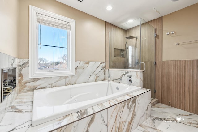 bathroom featuring shower with separate bathtub