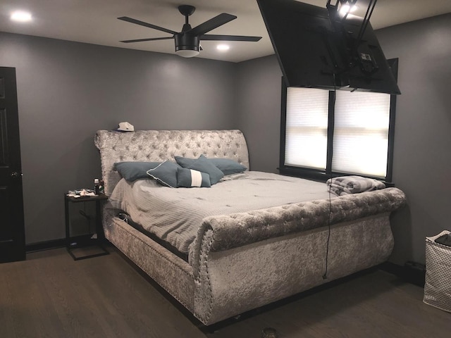 bedroom with dark hardwood / wood-style floors and ceiling fan