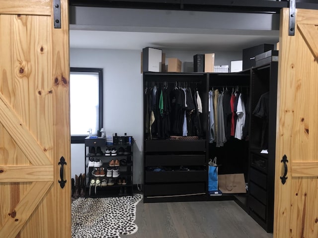 interior space featuring a barn door and dark hardwood / wood-style floors