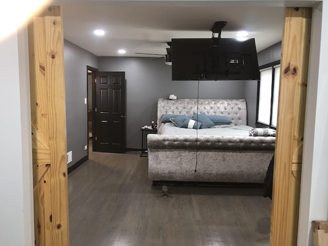 bedroom with ceiling fan and dark hardwood / wood-style flooring