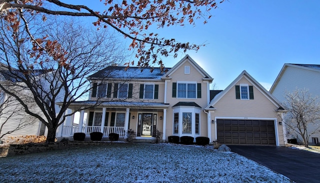 view of front facade with covered porch and a garage