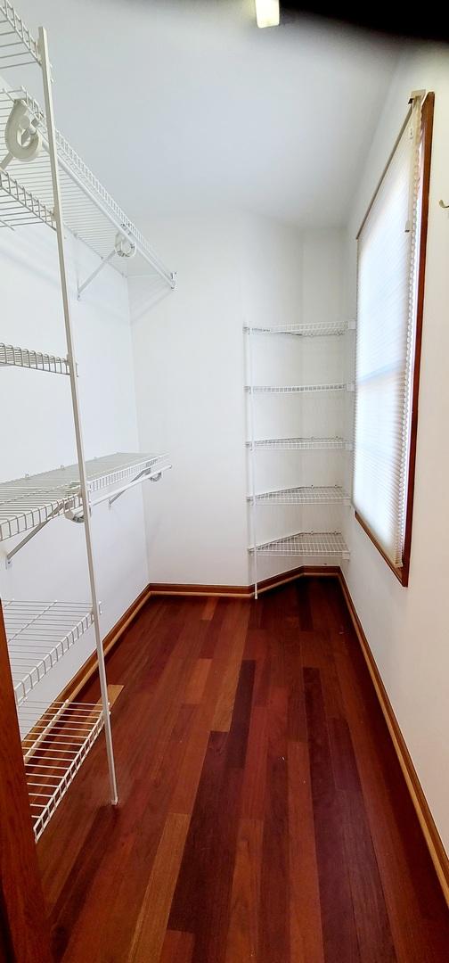 spacious closet featuring hardwood / wood-style floors