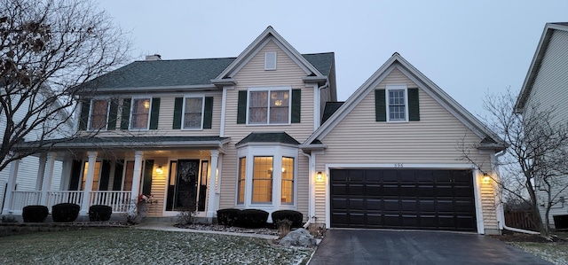 view of front of property featuring a porch and a garage