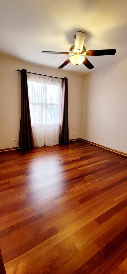 unfurnished room featuring hardwood / wood-style flooring and ceiling fan