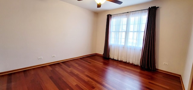 spare room with ceiling fan and dark hardwood / wood-style flooring