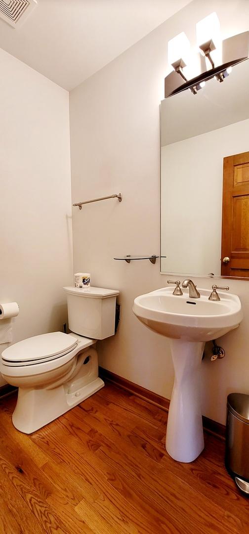 bathroom with wood-type flooring and toilet