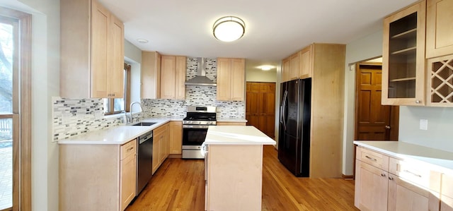 kitchen with a kitchen island, sink, stainless steel appliances, and light brown cabinetry