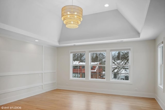 empty room featuring light hardwood / wood-style floors, plenty of natural light, and lofted ceiling