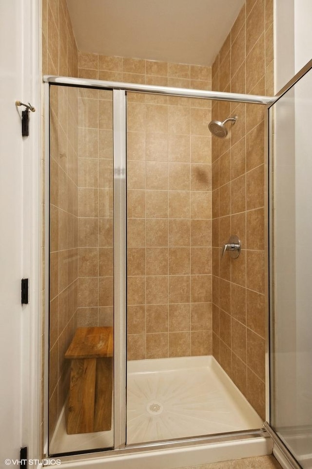 bathroom with a shower with shower door