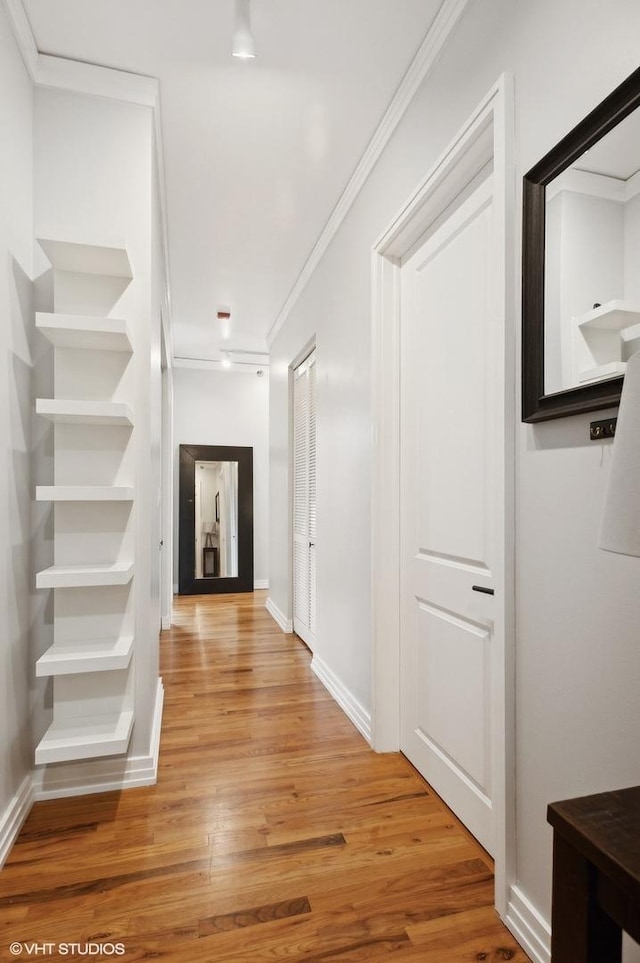 hallway featuring hardwood / wood-style flooring and ornamental molding