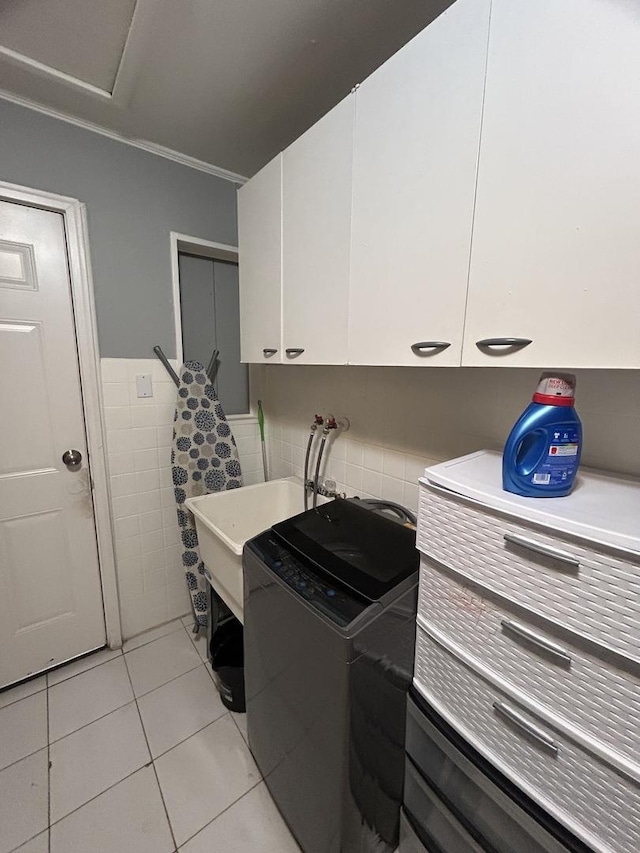 washroom with sink, ornamental molding, cabinets, and light tile patterned flooring