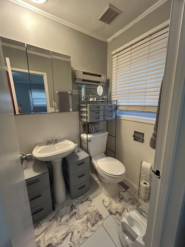 bathroom with ornamental molding, toilet, a wall mounted AC, and sink