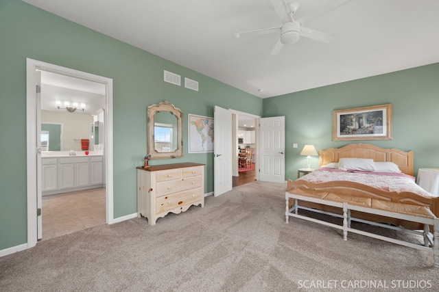 carpeted bedroom with ensuite bath, ceiling fan, and sink