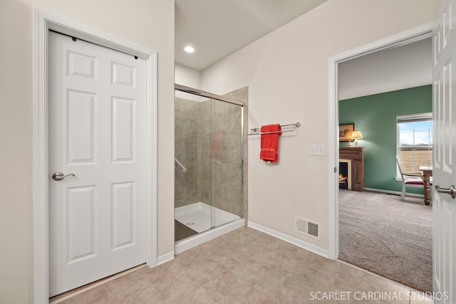 bathroom featuring a shower with door