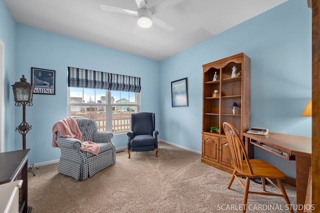 carpeted office featuring ceiling fan