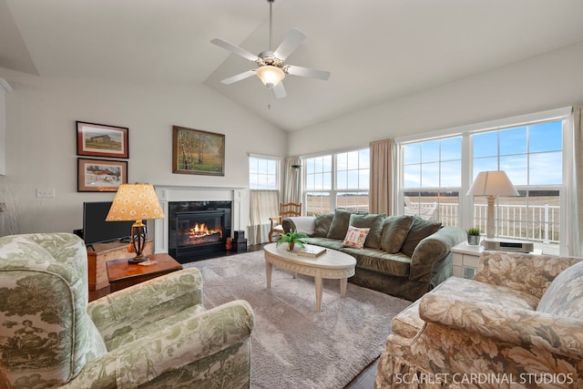 living room featuring a fireplace, ceiling fan, and lofted ceiling