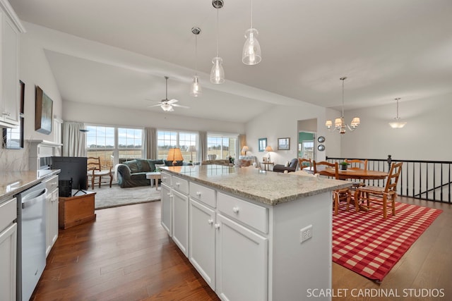 kitchen featuring white cabinetry, a center island, ceiling fan with notable chandelier, and lofted ceiling