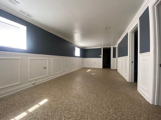 empty room featuring crown molding