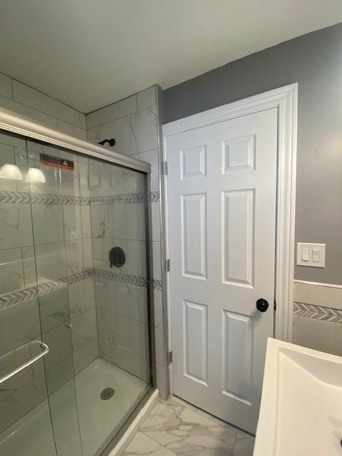 bathroom with a shower with shower door