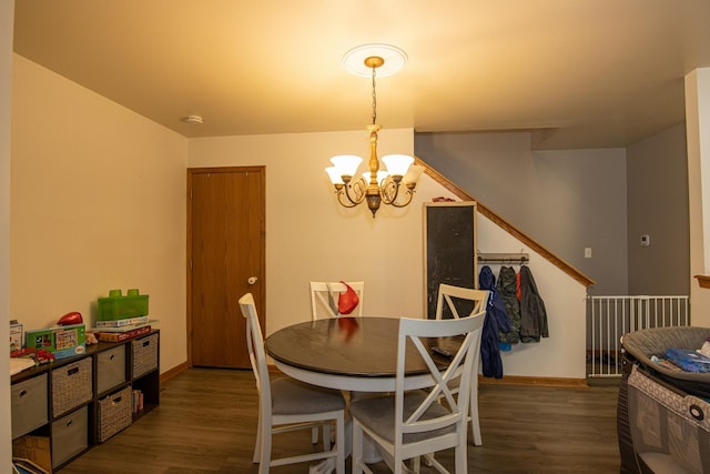 dining space with dark hardwood / wood-style floors and a notable chandelier