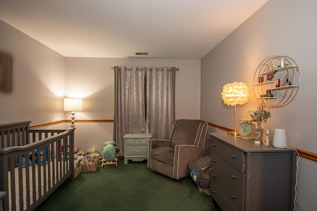 carpeted bedroom featuring a nursery area