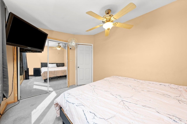 carpeted bedroom featuring a closet and ceiling fan