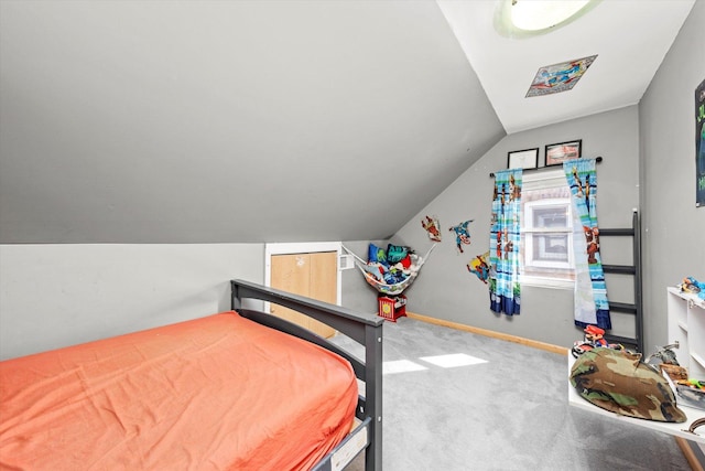 bedroom featuring vaulted ceiling, carpet, and baseboards