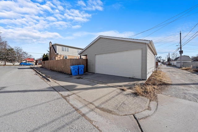 detached garage featuring fence