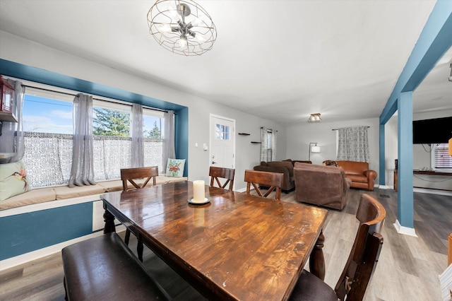 dining area with baseboards and wood finished floors