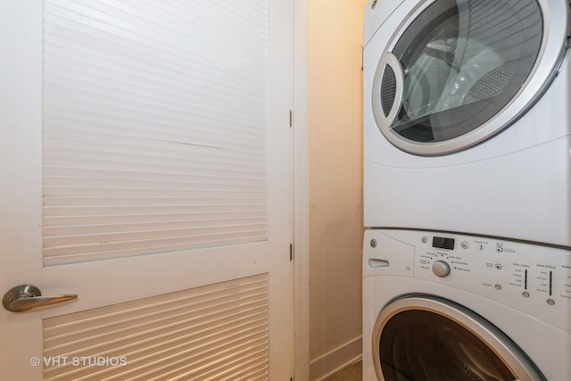 laundry room with stacked washing maching and dryer