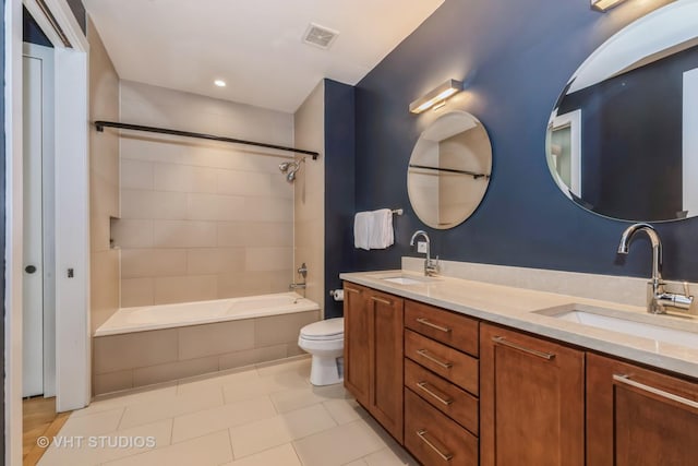 full bathroom featuring toilet, tiled shower / bath combo, tile patterned floors, and vanity