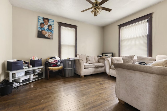 living room featuring dark hardwood / wood-style floors and ceiling fan