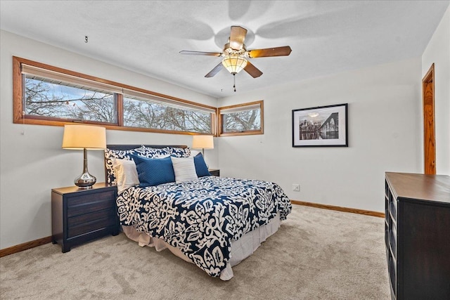 bedroom featuring ceiling fan and light carpet