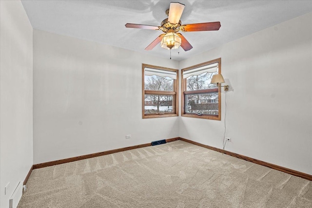 spare room with carpet and ceiling fan