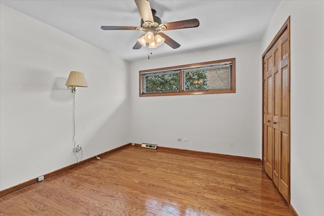 empty room featuring light hardwood / wood-style flooring and ceiling fan