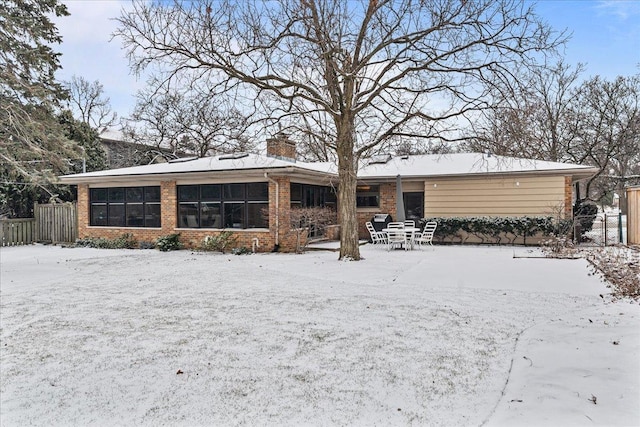 view of snow covered rear of property