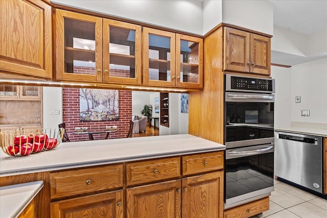 kitchen featuring light tile patterned flooring and stainless steel appliances