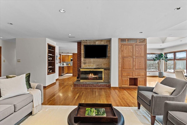 living room with a fireplace and light hardwood / wood-style flooring