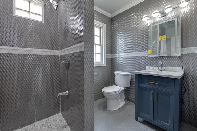 bathroom with tile patterned floors, ornamental molding, vanity, tile walls, and toilet