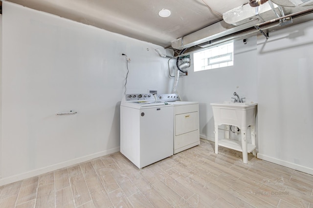 washroom featuring washer and dryer and light hardwood / wood-style flooring