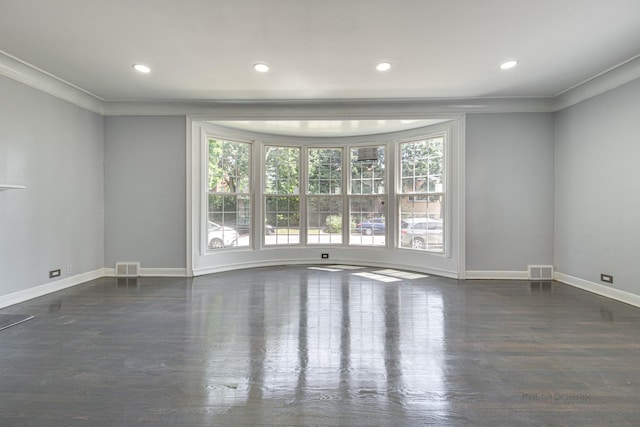 empty room featuring crown molding