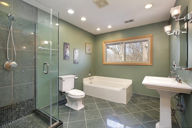 full bathroom featuring toilet, tile patterned flooring, shower with separate bathtub, and sink