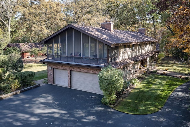 view of front of house featuring a sunroom and a garage