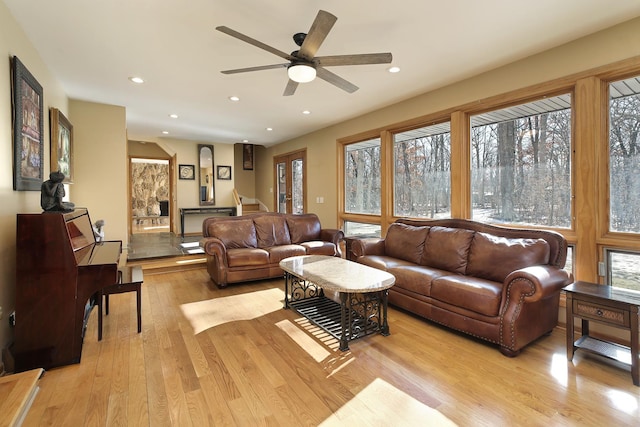 living room with ceiling fan and light hardwood / wood-style floors