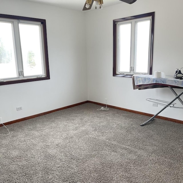 empty room with carpet flooring and ceiling fan