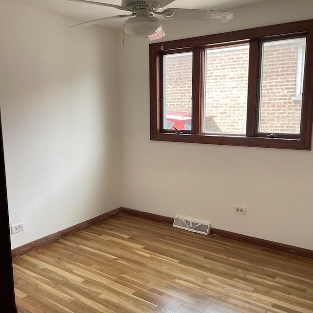 spare room featuring ceiling fan and light hardwood / wood-style floors