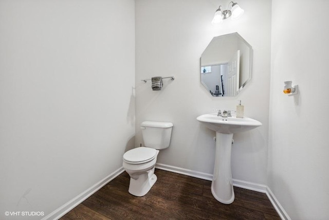 bathroom featuring hardwood / wood-style floors and toilet