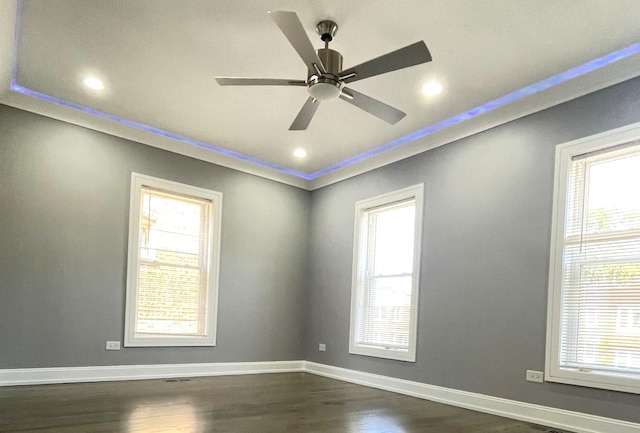 unfurnished room with crown molding, ceiling fan, and dark wood-type flooring