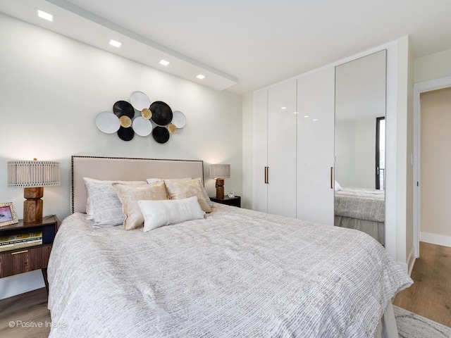 bedroom with dark hardwood / wood-style flooring