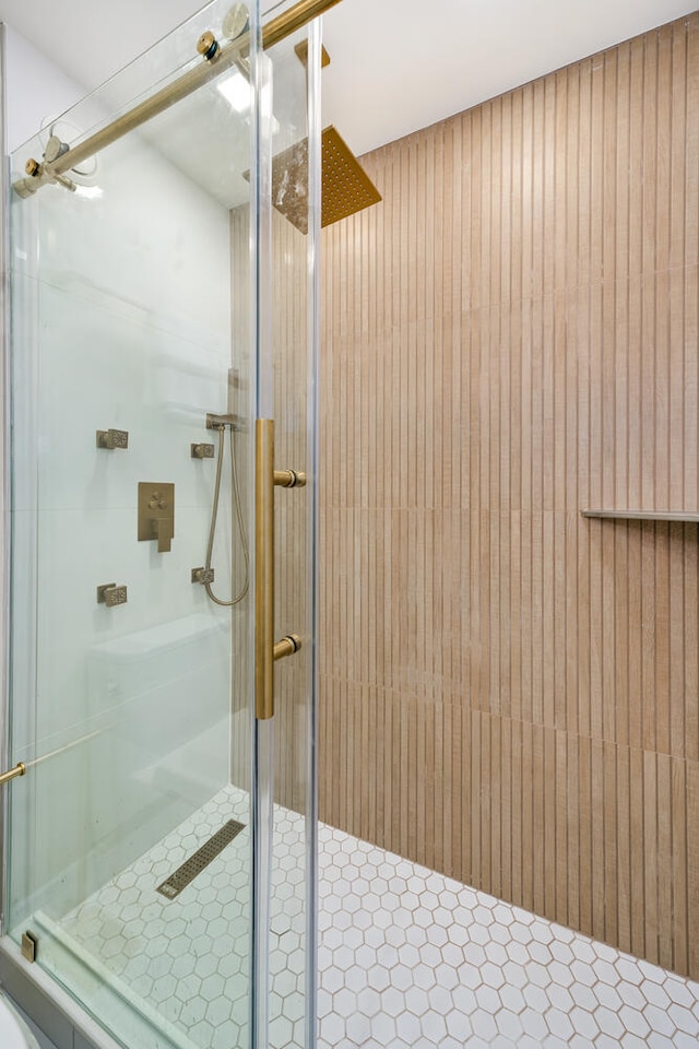 bathroom with a shower with shower door